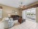 Bright living room with neutral tones, tile flooring, and direct access to the sunroom at 17787 Se 114Th Ave, Summerfield, FL 34491