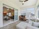 Bright sunroom with tile flooring, desk, and view of the home's interior at 17787 Se 114Th Ave, Summerfield, FL 34491