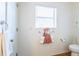 A bathroom area features a towel rack and toilet at 1806 Estafana Way, The Villages, FL 32159