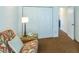 Comfortable bedroom with a floral sofa, closet, and view to another room at 1806 Estafana Way, The Villages, FL 32159