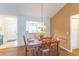 The dining room features a dark wood table and earth-toned colors at 1806 Estafana Way, The Villages, FL 32159