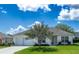 Charming single-story home featuring a well-manicured lawn and an attached two-car garage at 1806 Estafana Way, The Villages, FL 32159