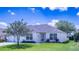 Inviting single-story home with a lush green lawn, simple landscaping, and a welcoming front entrance at 1806 Estafana Way, The Villages, FL 32159