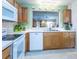 Functional kitchen with white appliances and a view of the living room at 1806 Estafana Way, The Villages, FL 32159