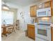Cozy kitchen area features an adjacent dining table, bright window and white appliances at 1806 Estafana Way, The Villages, FL 32159