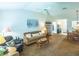 Inviting living space with vaulted ceilings and seamless flow to dining area at 1806 Estafana Way, The Villages, FL 32159