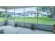 Enjoy the outdoors on this screened-in patio with plants and views to the backyard at 1806 Estafana Way, The Villages, FL 32159