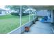 Enjoy the outdoors on this screened-in patio with plants and views to the backyard at 1806 Estafana Way, The Villages, FL 32159