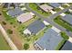 Aerial view showcases a home with a well-kept yard, landscaping and pergola at 2001 Dagenais Way, The Villages, FL 32163