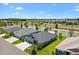 Aerial view of a home by a lake, showcasing its well-manicured lawn and landscaping at 2001 Dagenais Way, The Villages, FL 32163