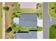Overhead aerial of a home and it's landscaping with water in the background at 2001 Dagenais Way, The Villages, FL 32163