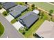 Aerial view of a well-manicured lawn and landscaping for this home near a lake at 2001 Dagenais Way, The Villages, FL 32163