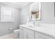 Bright bathroom featuring white cabinets, stone countertop, large mirror, and updated shower at 2001 Dagenais Way, The Villages, FL 32163