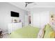 Cozy bedroom with a green comforter and a light interior at 2001 Dagenais Way, The Villages, FL 32163