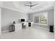 Bright bedroom with white desk, large windows with shutters, a ceiling fan, and neutral décor at 2001 Dagenais Way, The Villages, FL 32163