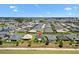 Aerial view of a planned community with homes surrounding waterways and lush landscaping at 2001 Dagenais Way, The Villages, FL 32163