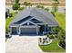 Beautiful single-Gathering home boasts a spacious driveway, three-car garage, and well-manicured landscaping at 2001 Dagenais Way, The Villages, FL 32163