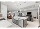 Open-concept kitchen features a large island, stainless steel appliances, and breakfast bar seating at 2001 Dagenais Way, The Villages, FL 32163