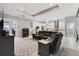 Open-concept living room featuring a tray ceiling, recessed lighting, and seamless flow into the modern kitchen at 2001 Dagenais Way, The Villages, FL 32163