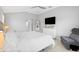 The main bedroom features neutral walls, a ceiling fan, and ensuite bathroom access at 2001 Dagenais Way, The Villages, FL 32163