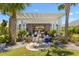 Beautiful outdoor patio with a pergola, stone flooring, and tropical landscaping creates a relaxing backyard retreat at 2001 Dagenais Way, The Villages, FL 32163