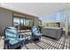 Relaxing covered patio featuring comfortable seating and a luxurious hot tub for ultimate outdoor enjoyment at 2001 Dagenais Way, The Villages, FL 32163