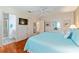 Bedroom featuring a bathroom, television and hardwood floors at 2063 Thornton Ter, The Villages, FL 32162