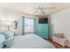 Bright bedroom with blue accents, hard wood floors and a bright window at 2063 Thornton Ter, The Villages, FL 32162