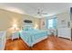 Inviting bedroom with a large bed, hardwood floors, and a ceiling fan at 2063 Thornton Ter, The Villages, FL 32162