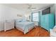 Serene bedroom with blue accents, wood floors, and a bright, airy feel at 2063 Thornton Ter, The Villages, FL 32162