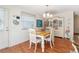 Traditional dining room featuring a wood table with seating for four under an elegant chandelier fixture at 2063 Thornton Ter, The Villages, FL 32162