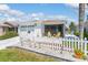 Well-maintained single-story home with white siding, two-car garage, and a tidy landscaped front yard at 2063 Thornton Ter, The Villages, FL 32162
