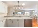 Open kitchen with a breakfast bar flowing seamlessly into a dining area and living space at 2063 Thornton Ter, The Villages, FL 32162