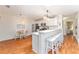 Modern kitchen with stainless steel appliances, white cabinets, breakfast bar, and adjacent dining area at 2063 Thornton Ter, The Villages, FL 32162