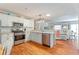Open kitchen flows into the living area, featuring stainless steel appliances and lots of counter space at 2063 Thornton Ter, The Villages, FL 32162