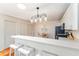 Bright kitchen features modern lighting, white cabinetry, and a breakfast bar with seating at 2063 Thornton Ter, The Villages, FL 32162