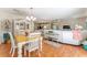 Open-concept living space with a dining area, living room with white sofa, and hardwood floors at 2063 Thornton Ter, The Villages, FL 32162