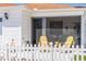 Inviting screened-in patio featuring cozy seating and a view of the manicured yard at 2063 Thornton Ter, The Villages, FL 32162
