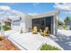 Inviting screened-in patio featuring cozy seating and a view of the manicured yard at 2063 Thornton Ter, The Villages, FL 32162