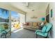 Bright sunroom with comfortable seating, tile flooring, and lots of natural light at 2063 Thornton Ter, The Villages, FL 32162