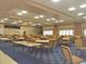 A large banquet hall with tables, chairs, and blue patterned carpeting, perfect for events and gatherings at 2126 Burley Ave, Clermont, FL 34711
