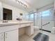 Clean bathroom with vanity, toilet, and glass enclosed shower with grab bar at 2126 Burley Ave, Clermont, FL 34711