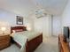 Bedroom featuring ceiling fan, wood furnishings and decor art at 2126 Burley Ave, Clermont, FL 34711