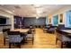 A spacious dining area features wood floors, tables, and cushioned chairs, creating a comfortable place to gather at 2126 Burley Ave, Clermont, FL 34711