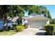 Well-maintained house with lush landscaping, two car garage and American flag at 2126 Burley Ave, Clermont, FL 34711