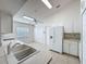 Open kitchen featuring white cabinets, ample counter space, and tile floors at 2126 Burley Ave, Clermont, FL 34711