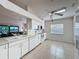 Bright kitchen featuring white cabinets, tile flooring, and stainless steel appliances at 2126 Burley Ave, Clermont, FL 34711