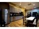 A modern kitchenette includes stainless steel appliances, cabinets, and tables with chairs for casual dining at 2126 Burley Ave, Clermont, FL 34711