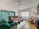 Bright living room with a ceiling fan, comfortable couches and view to the lanai at 2126 Burley Ave, Clermont, FL 34711