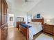 Spacious main bedroom featuring wood floors, vaulted ceiling, and ensuite bathroom at 2126 Burley Ave, Clermont, FL 34711